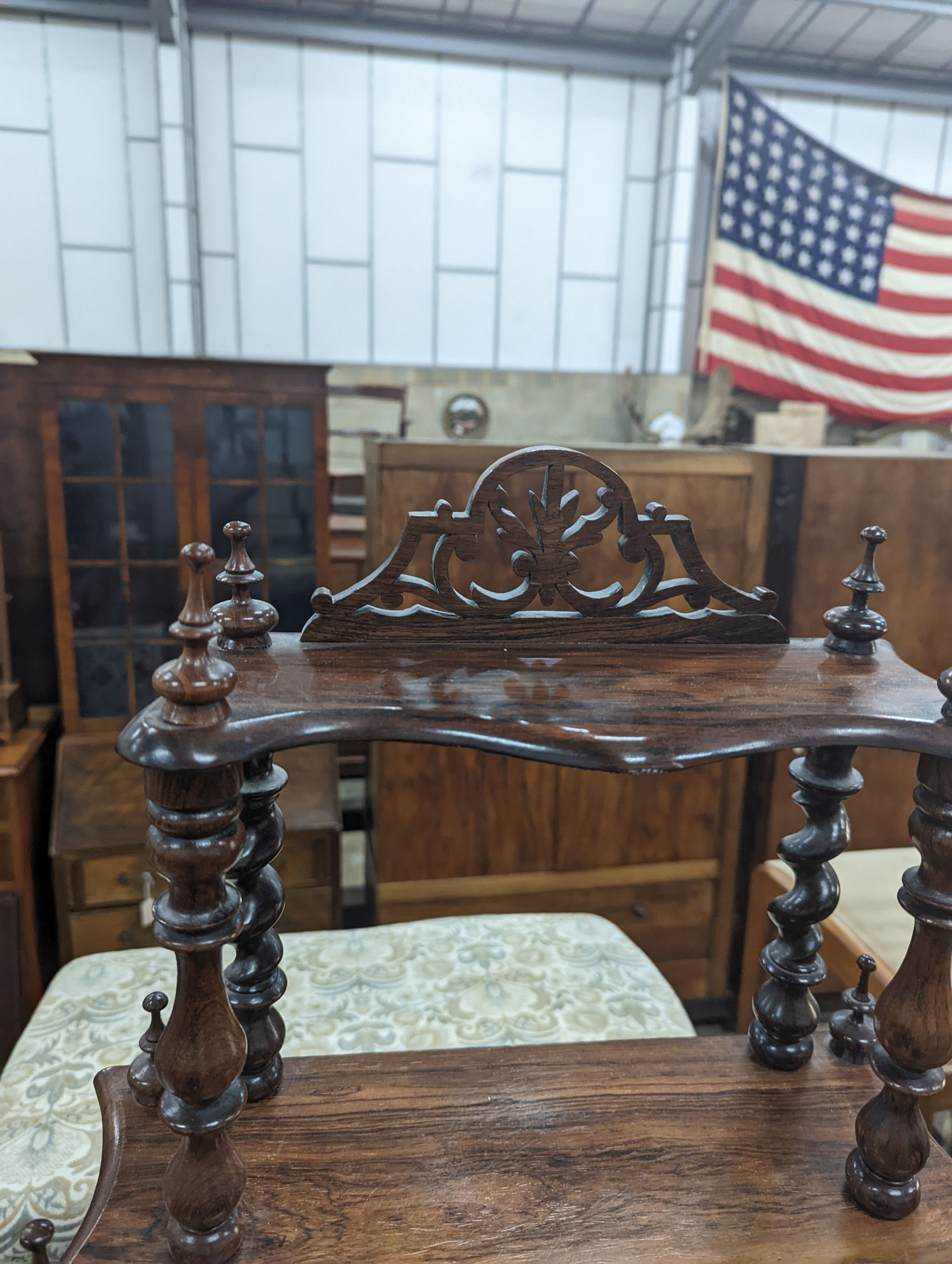 A small Victorian rosewood serpentine fronted four tier whatnot, width 61cm, depth 21cm, height 94cm